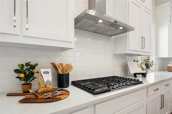 a kitchen with a stove and cabinets