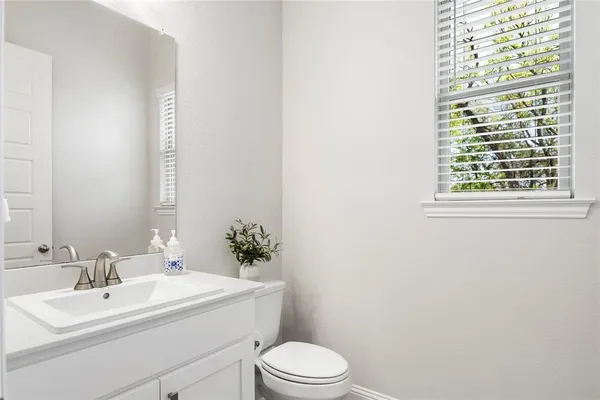 a bathroom with a sink toilet and a mirror