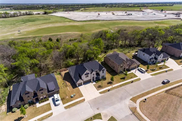 an aerial view of a house with a garden and lake view