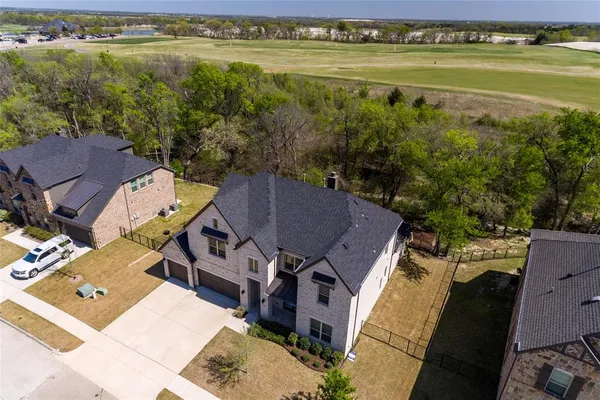 an aerial view of a house with a lake view