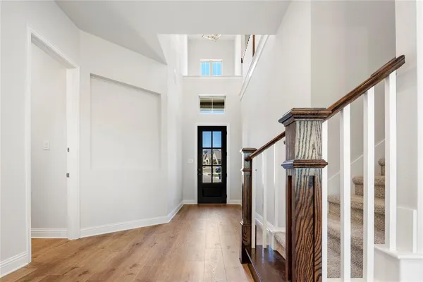 a view of an entryway with wooden floor and stairs