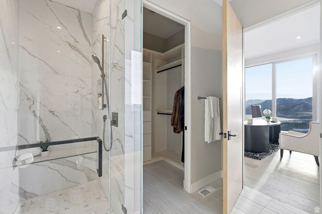 2002 East Outlaw Road Kamas, UT 84036 - Photo 63 of 65 Glass-enclosed shower with marble-finish tile walls and a built-in shelf