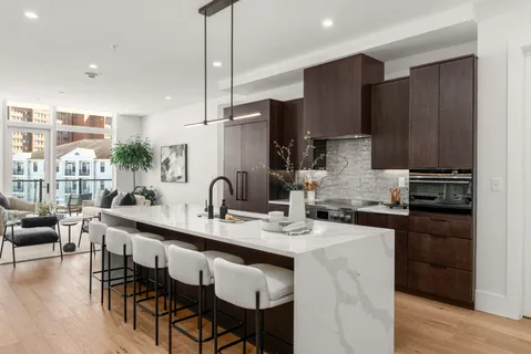 a kitchen with granite countertop a sink stainless steel appliances and cabinets