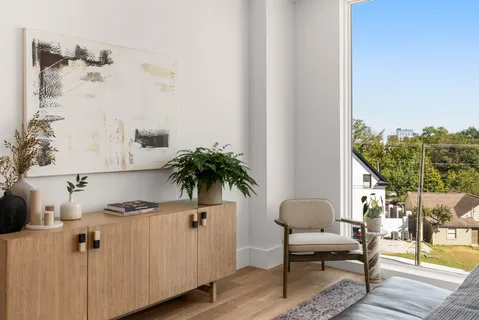 a very nice looking living room with a large window and furniture