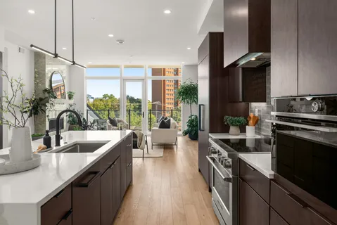 a kitchen with a table and potted plant