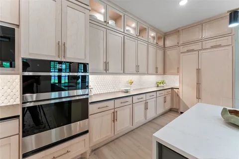 a kitchen with granite countertop white cabinets and white appliances