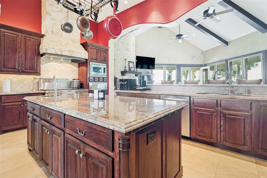 1237 Overlook Court Whitney, TX 76692 - Photo 7 of 20 a kitchen with granite countertop a sink and dishwasher cabinets with wooden floor