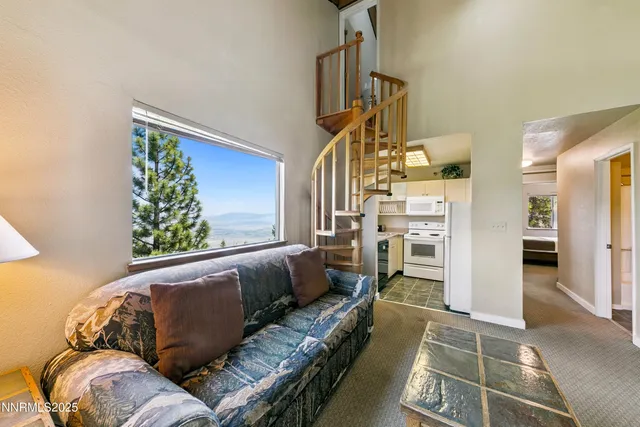 a living room with furniture a dining table and a fireplace