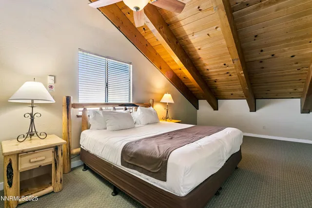 a bedroom with a bed a lamp and a window