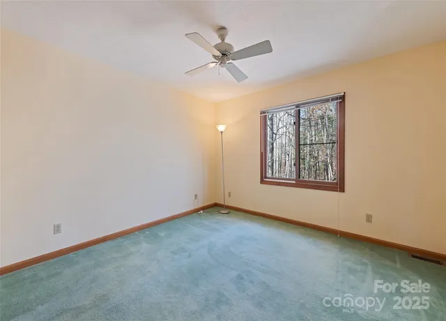 a bathroom with a double vanity sink and mirror with large window