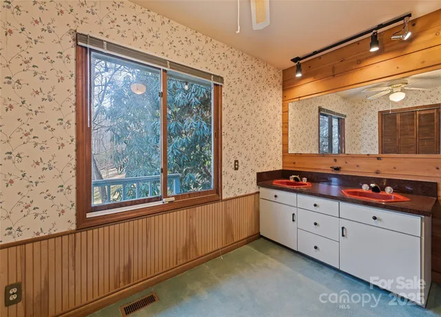 a view of an empty room with wooden walls