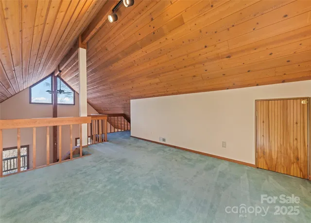 an empty room with a chandelier fan