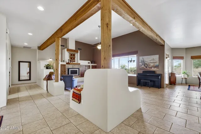 a bedroom with a bed and painting on the wall