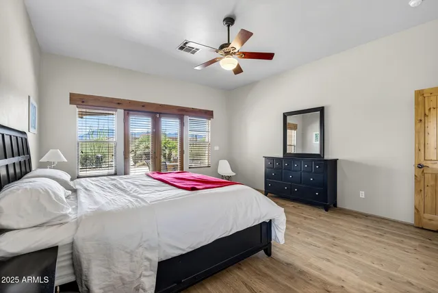 a living room with furniture and a ceiling fan