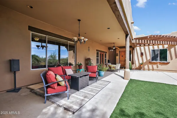 an aerial view of residential houses with outdoor space and seating