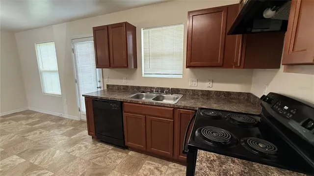 a kitchen with a stove and a sink