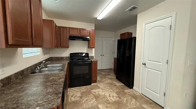 a kitchen with a refrigerator and a stove