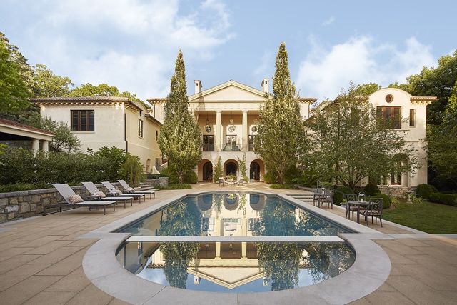 a view of a house with swimming pool and sitting area