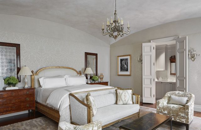 a bedroom with a bed and a chandelier