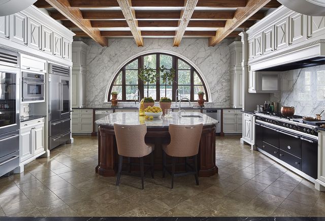 a view of a dining room with furniture a kitchen and chandelier