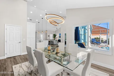 a view of a dining room with furniture wooden floor and chandelier