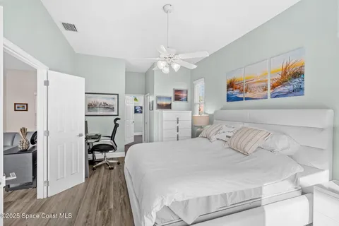 a bedroom with a bed and a chandelier