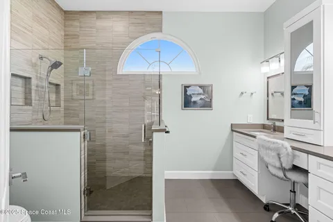 a bathroom with a double vanity sink a toilet a shower and a mirror