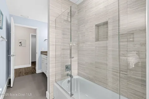 a bathroom with a bathtub and a shower