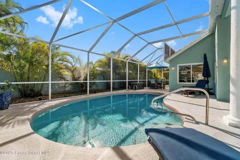 a view of a swimming pool with chairs and tables