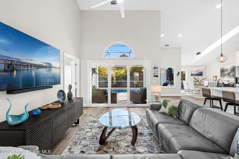 a living room with furniture a table and a large window