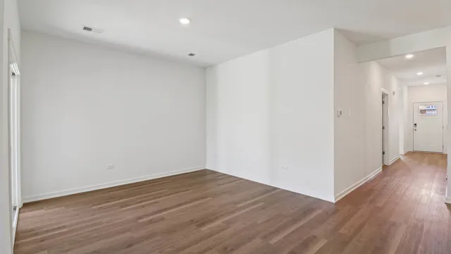 a view of a room with wooden floor