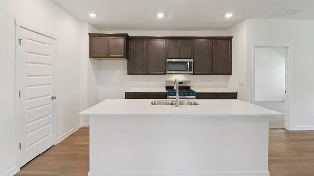 a kitchen with stainless steel appliances a refrigerator and microwave