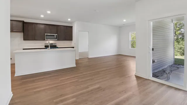 a view of kitchen with wooden floor and electronic appliances