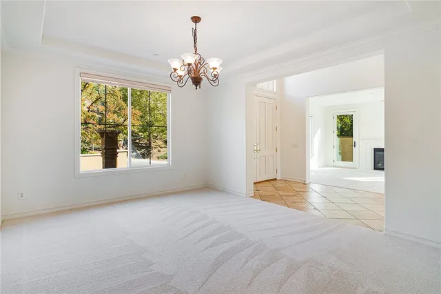 an empty room with windows and entrance