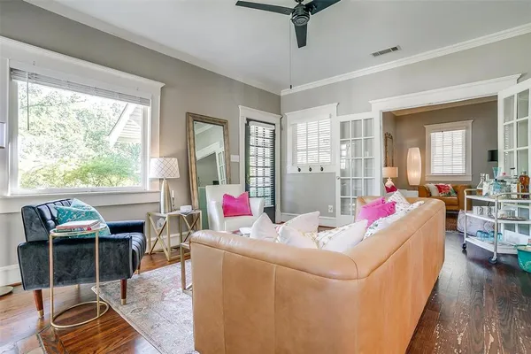 a living room with furniture and a wooden floor