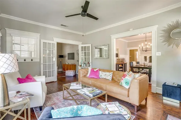 a living room with furniture and wooden floor
