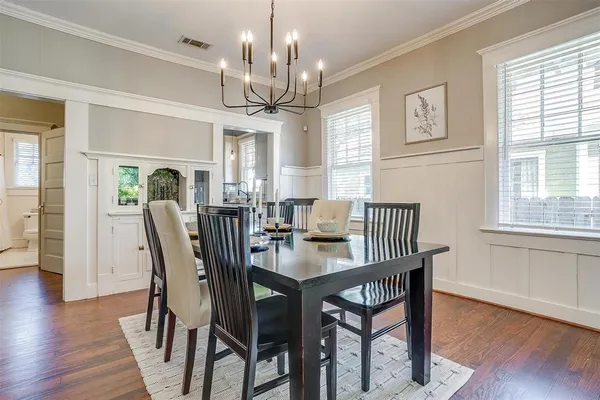 a view of a dining room with furniture wooden floor and chandelier