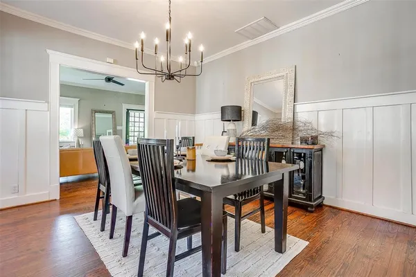 a view of a dining room with furniture wooden floor and chandelier