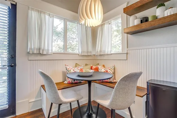 a dining room with furniture and window