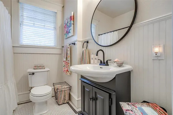 a bathroom with a sink a toilet and a mirror
