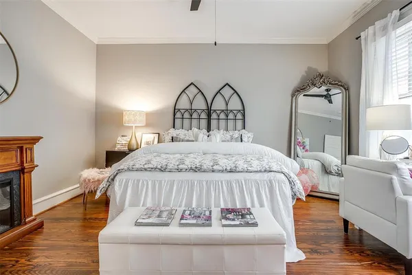 a bed sitting in a bedroom next to a window with a mirror