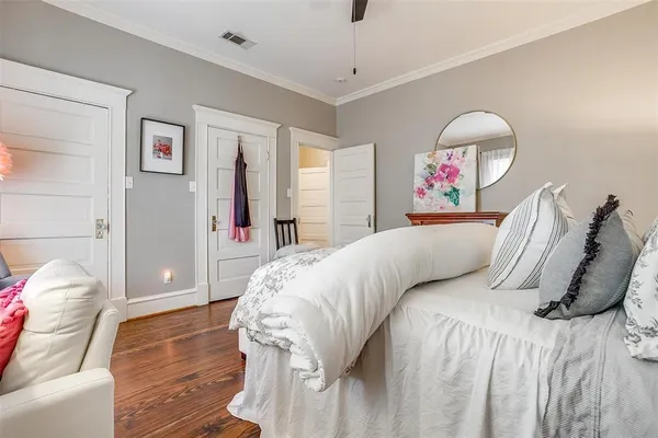 a bed room with a bed and a painting on the wall