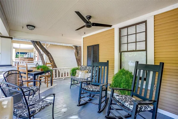 a living room with furniture a window and wooden floor