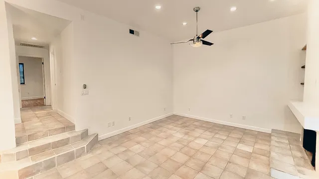 a view of a room with window and wooden floor