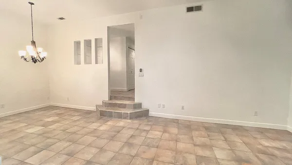 a view of a room with wooden floor and windows