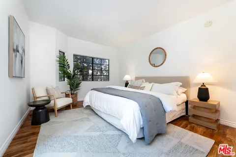 a bedroom with bed and window