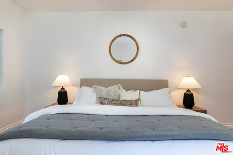 a bedroom with a bed and a lamp