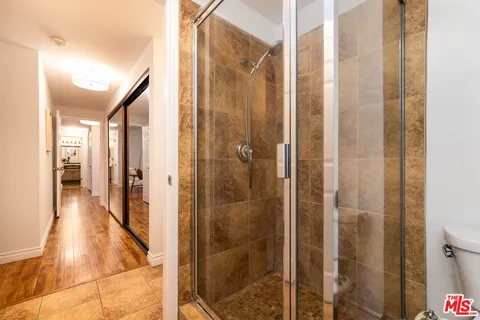 a bathroom with a shower and a glass door