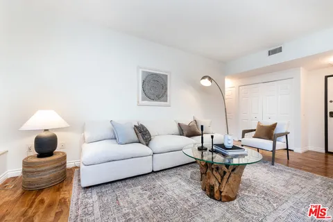 a living room with furniture and a lamp