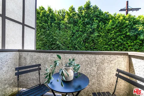 a view of a balcony with table and chairs